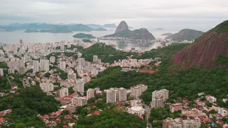 Establishing-Rio-de-Janeiro-and-Guanabara-Bay-Brazil-on-a-cloudy-day,-drone-flyover