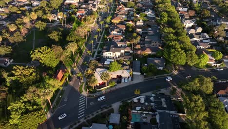 Aerial-View-of-Culver-City,-Residential-Neighborhood-of-Homes-and-Street-Traffic-on-Golden-Hour-Sunlight