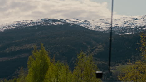 Slow-motion-POV-panning-shot-showing-snow-covered-mountains-with-a-lake-below-in-Norway