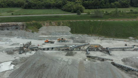 Aerial-Flyover-of-Truck-Driving-in-Limestone-Sand-Quarry-for-Construction-Supply