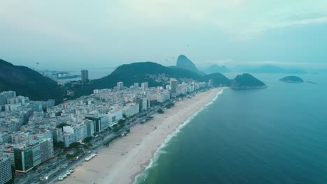 Bird's-eye-view-of-Copacabana-Rio-de-Janeiro-in-the-blue-hour-birds-flying-Guanabara-bay-Brazil