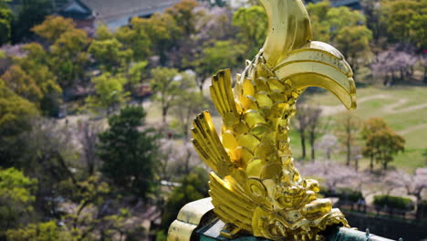 Slow-motion-panning-shot-of-golden-accents-on-the-Osaka-Castle,-Japan