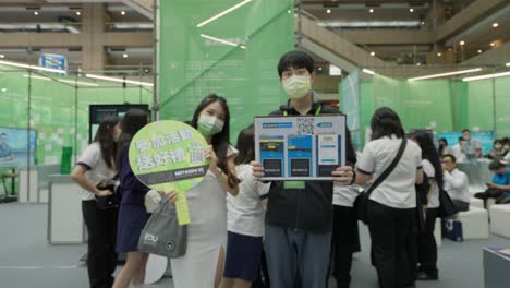 Showgirl-and-guy-waving-to-the-camera-in-a-technology-expo-summit-event