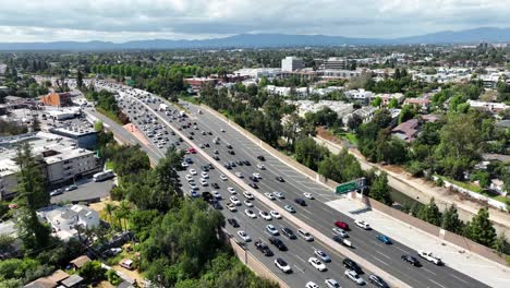 US-Highway-route-101-through-Hollywood,-California---aerial-flyover-during-heavy-traffic