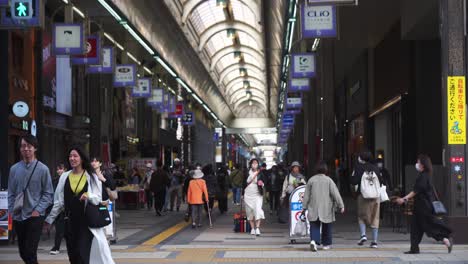 View-Looking-Through-Tanukikoji-Shopping-Arcade-With-People-Walking-Past-In-Sapporo,-Japan