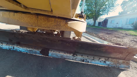 POV-Shot-of-Grader-Blade-Smoothing-Surface-during-Road-Construction