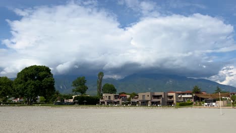 Dion-Palace-Resort-and-Spa-bungalows-against-the-backdrop-of-Mount-Olympus,-the-highest-mountain-in-Greece,-shrouded-in-big-white-clouds