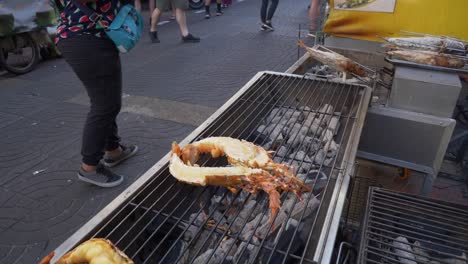 grilled-halved-lobster-on-charcoal-fire-cooking-at-Asian-thailand-street-food-booth-for-sale