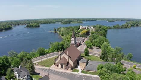 Aerial-wide-panning-shot-of-a-Lutheran-Church-on-the-lake-in-Center-City,-Minnesota
