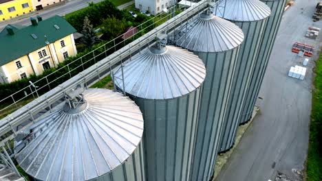 Metal-Grain-Silos-On-Agro-processing-Manufacturing-Plant---drone-shot