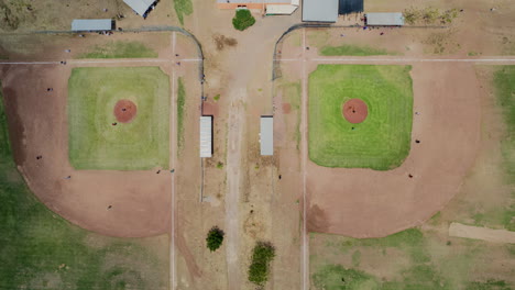 Hyperlapse-of-baseball-games-in-action,-captured-from-an-overhead-perspective-at-midday,-with-cloud-shadows-passing-over