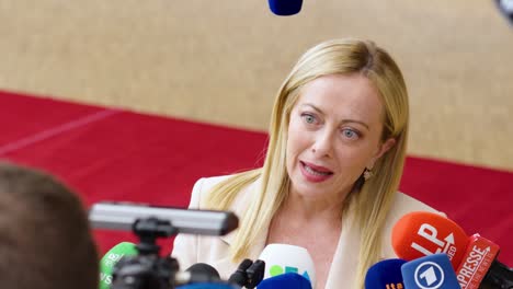 Italian-Prime-Minister-Giorgia-Meloni-talking-to-the-press-at-the-European-Council-top-in-Brussels,-Belgium---Close-shot