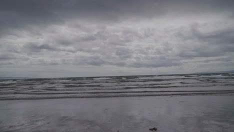 On-a-very-overcast-day-with-grey-clouds-sea-water-flows-in-slow-motion