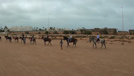 Slow-motion-of-horse-caravan-with-tourists-on-horseback-in-Tunisia