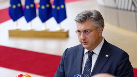 Prime-Minister-of-Croatia-Andrej-Plenkovic-giving-an-interview-during-the-European-Council-summit-in-Brussels,-Belgium---Slow-motion-shot