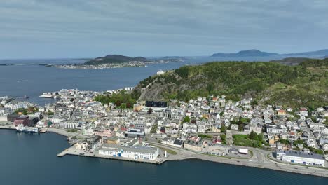 Alesund-panoramic-summer-aerial-approaching-coastal-city-and-Aksla-viewpoint-slowly-from-seaside---Islands-and-Atlantic-ocean-in-background