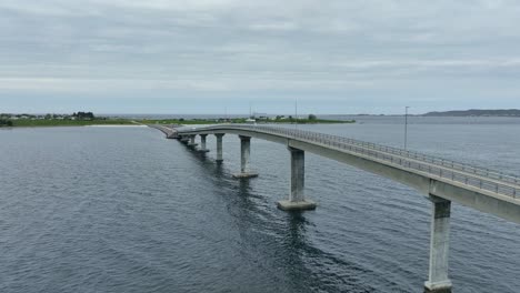 Giske-bridge-outside-Alesund-Norway---Forward-moving-aerial-beside-bridge-with-Gjerdesanden-beach-in-background