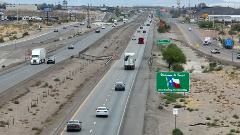 Welcome-to-Texas-sign-along-interstate-highway-in-desert-region