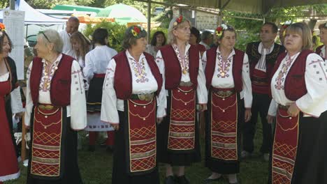 Folk-group-of-nervous-elderly-ladies-wait-to-go-on-stage-at-festival