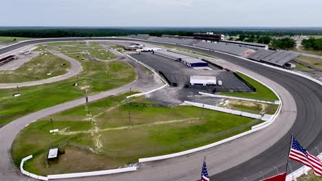 aerial-over-american-flags-at-rockingham-speedway,-north-carolina-motor-speedway