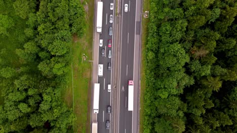 Top-down-view-of-2-lane-highway-congested-with-heavy-traffic-on-a-national-road-in-European-country-from-a-drone
