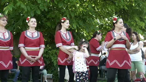 Little-girl-with-mum-in-traditional-dress-looks-bored-at-dance-festival