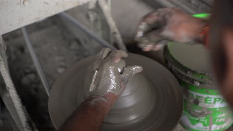A-potter-is-making-clay-objects-with-a-pot