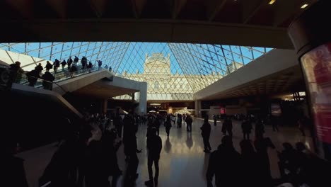 Pan-up-reveals-past-ceiling-of-Louvre-Paris-to-iconic-glass-pyramid