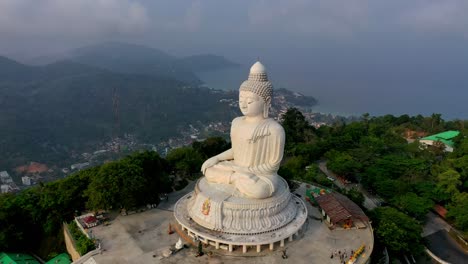 Aerial-establish-shot-of-sunset-serpent-statue-at-Karon-beach-Naka-god-of-snake-statue-in-the-middle-of-Karon-beach-Phuket