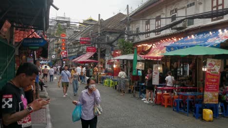 Chinatown-with-People-Walking-Past-Restaurants-in-Bangkok,-Thailand