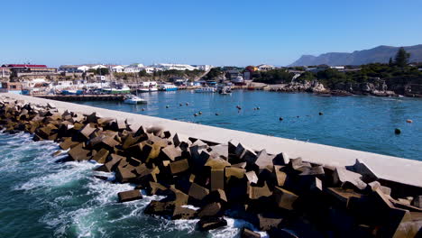 Aerial-dolly-over-pier-protected-by-dolosse-breakwater-at-Hermanus-New-Harbour