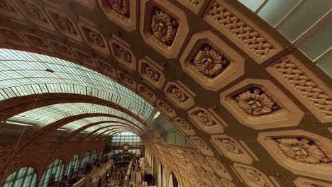 Interior-roof-arch-decorations-in-Musee-d'orsay,-high-angle-pan