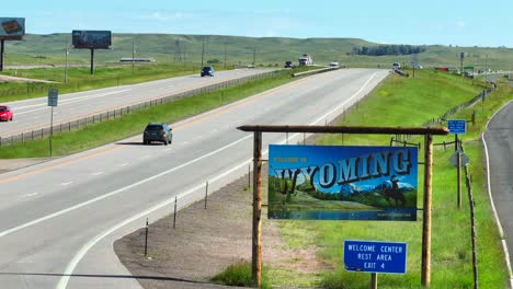 Welcome-to-Wyoming-state-border-road-sign-along-interstate-highway-in-Great-Plains-in-USA
