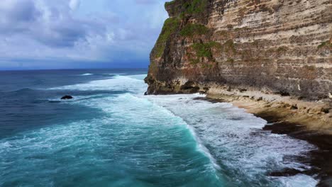 Uluwatu-Sea-Cliffs-In-Bali,-Indonesia---drone-shot