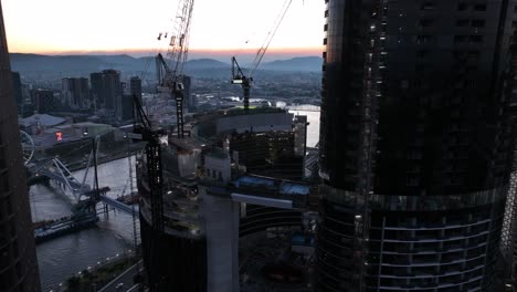 Aerial-Pull-away-and-pan-up-shot-of-the-top-of-Brisbane-City's-Queens-Wharf-Casino-development