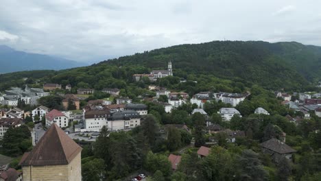 Medieval-Church-Building-Towers-in-Mountains-of-Annecy,-France---Aerial-Drone-View
