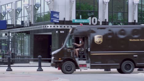 UPS-truck-turning-on-the-corner-of-Washington-and-Michigan-in-downtown-Lansing,-Michigan-with-stable-video