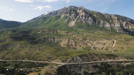 Mount-Timpanogos-Peak-over-a-highway-full-of-cars-traveling-during-summer-in-the-USA