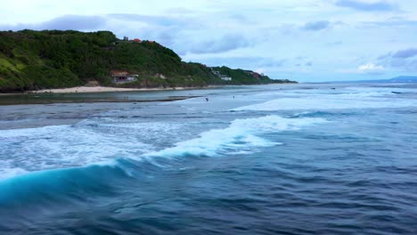 Sea-Waves-Rolling-At-Gunung-Payung-Beach-In-Bali,-Indonesia---drone-shot