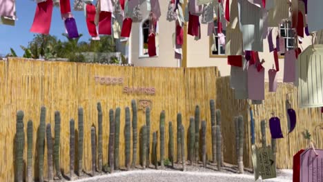 Gimbal-move-reveals-a-fence-with-Todos-Santos-sign-in-Baja-California-Sur,-Mexico