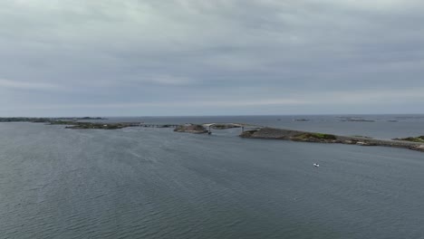 Atlantic-Ocean-Road---Aerial-aproaching-road-from-a-distance-with-Storseisundet-bridge-in-middle-of-frame-and-Ocean-with-horizon-in-background