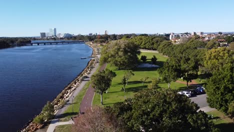 Drone-shot-descending-over-Optus-Stadium,-Crown-Casino-Burswood,-Swan-River-and-Causeway-Bridge