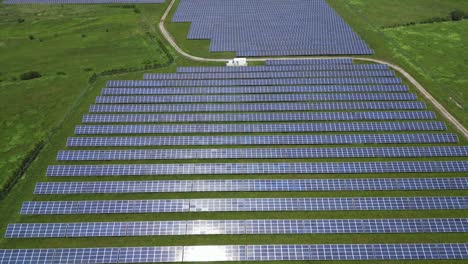 Aerial-View-Over-Solar-Plant-In-Green-Field---drone-shot