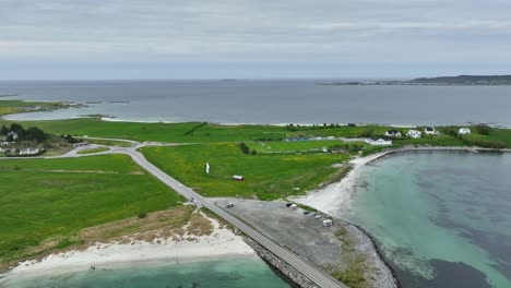 Sandvika-and-Gjerdesanden-beach-at-Giske-Island-outside-Aalesund-in-Norway---Aerial-of-island-with-bridge-and-beach-surrounded-by-ocean