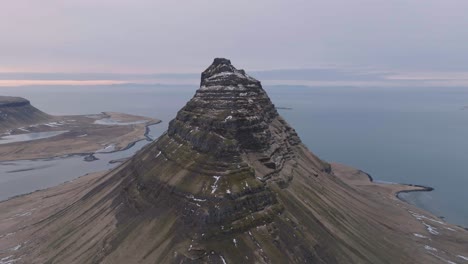 Aerial-View-of-Kirkjufell-Volcanic-Hill,-North-Coast-of-Iceland-and-Snæfellsnes-Peninsula,-Drone-Shot
