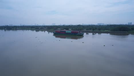 Fly-in-to-container-boat-on-Saigon-river-from-aerial-view-on-sunny-day