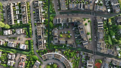 Top-down-aerial-view-of-housing-project-with-condos,-apartments,-and-parking