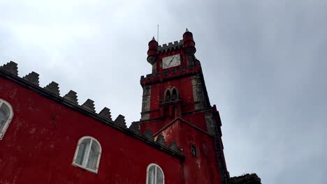 Tilt-up-shot-showing-historic-red-colored-clock-tower-of-Pena-Palace-in-Sintra