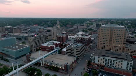 Downtown-Davenport,-Iowa-skyline-during-sunset-with-drone-video-circling-right-to-left