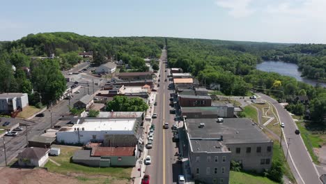 Low-aerial-shot-flying-over-the-small-town-of-Saint-Croix-Falls,-Wisconsin